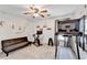 Home gym with a ceiling fan, a treadmill, exercise bike, and a cozy couch at 1712 Green Farm Cir, Dacula, GA 30019