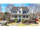 Charming two-story home with a covered front porch and manicured landscaping at 1712 Green Farm Cir, Dacula, GA 30019