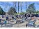 Backyard fire pit and seating area, perfect for outdoor entertaining, with privacy fence and mature trees at 1712 Green Farm Cir, Dacula, GA 30019