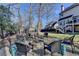 Backyard fire pit and seating area, perfect for outdoor entertaining, with privacy fence and mature trees at 1712 Green Farm Cir, Dacula, GA 30019