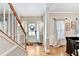 Bright foyer with hardwood floors and view of the front door and staircase at 1712 Green Farm Cir, Dacula, GA 30019