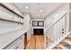 Bright hallway features marble countertop, custom cabinets and a wine cooler at 1712 Green Farm Cir, Dacula, GA 30019