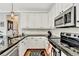 Modern kitchen featuring granite countertops, stainless steel appliances, and ample cabinet space at 1712 Green Farm Cir, Dacula, GA 30019