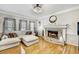 Comfortable living room with hardwood floors and a traditional brick fireplace at 1712 Green Farm Cir, Dacula, GA 30019