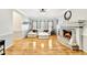 Bright living room features a cozy fireplace, hardwood floors, and a comfortable sectional sofa with many windows for natural light at 1712 Green Farm Cir, Dacula, GA 30019