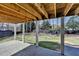 Covered patio overlooking the large backyard with a fire pit at 1712 Green Farm Cir, Dacula, GA 30019