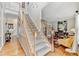 Elegant staircase leading to the upper level, adjacent to a stylishly decorated office space at 1712 Green Farm Cir, Dacula, GA 30019