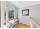Bright study nook with a large arched window, a glass-top desk, and built-in shelving at 1712 Green Farm Cir, Dacula, GA 30019