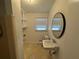 This bathroom features a shower, toilet, window, sink and storage at 239 Andrea Nw Cir, Lilburn, GA 30047