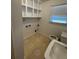 This bathroom features a window, toilet, sink and storage at 239 Andrea Nw Cir, Lilburn, GA 30047