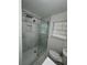 This bathroom features a seamless glass shower, window, and a toilet at 239 Andrea Nw Cir, Lilburn, GA 30047