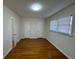 Bright bedroom with gleaming hardwood floors, white trim, and natural light from the window at 239 Andrea Nw Cir, Lilburn, GA 30047