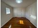 This bedroom features hardwood floors, neutral walls and ample closet space at 239 Andrea Nw Cir, Lilburn, GA 30047