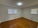 This bedroom features hardwood floors and two windows with mini blinds at 239 Andrea Nw Cir, Lilburn, GA 30047