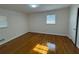 This bedroom is spacious with gleaming hardwood floors and lots of natural light at 239 Andrea Nw Cir, Lilburn, GA 30047