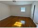 Cozy bedroom featuring hardwood floors, a window for natural light, and a serene ambiance at 239 Andrea Nw Cir, Lilburn, GA 30047