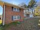 A two-story brick home with neat landscaping and classic window shutters, offering timeless curb appeal at 239 Andrea Nw Cir, Lilburn, GA 30047