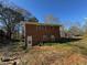 Brick exterior with door and window, surrounded by trees, sitting on a large sloping lot at 239 Andrea Nw Cir, Lilburn, GA 30047