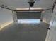 This garage features a sealed concrete floor and brick-lined walls at 239 Andrea Nw Cir, Lilburn, GA 30047
