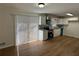 This kitchen features white cabinets, granite countertops, stainless appliances, and sleek floors at 239 Andrea Nw Cir, Lilburn, GA 30047