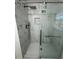This bathroom features a seamless glass shower with modern fixtures and attractive marble-style tile at 239 Andrea Nw Cir, Lilburn, GA 30047