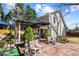 Landscaped backyard with pergola-covered patio, comfortable seating, and mature trees at 290 Leigh Kay Dr, Lawrenceville, GA 30046