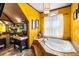 Bathroom featuring a large soaking tub, decorative walls, and unique lighting at 290 Leigh Kay Dr, Lawrenceville, GA 30046