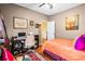 Cozy bedroom with hardwood floors, a ceiling fan and a nearby desk and chair at 290 Leigh Kay Dr, Lawrenceville, GA 30046