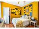 Bright bedroom features hardwood floors, ceiling fan, large sunflower art and white trim at 290 Leigh Kay Dr, Lawrenceville, GA 30046