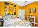 Bright bedroom with a unique sunflower accent wall and lots of natural light at 290 Leigh Kay Dr, Lawrenceville, GA 30046