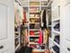 Well-organized walk-in closet with built-in shelves and hanging space for clothes and accessories at 290 Leigh Kay Dr, Lawrenceville, GA 30046