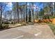 Long driveway leads to backyard with lush landscaping, a basketball court, and garden at 290 Leigh Kay Dr, Lawrenceville, GA 30046