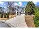 Wide view of a cozy home with an expansive driveway and manicured lawn at 290 Leigh Kay Dr, Lawrenceville, GA 30046