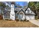 Charming home featuring a white exterior, well-manicured front yard and attached two-car garage at 290 Leigh Kay Dr, Lawrenceville, GA 30046