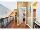 Second floor hallway with wood floors, decorative molding and access to bedroom and bath at 290 Leigh Kay Dr, Lawrenceville, GA 30046