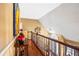 Hallway with decorative banister overlooking the entryway and hardwood flooring at 290 Leigh Kay Dr, Lawrenceville, GA 30046