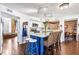 Modern kitchen with marble countertops, a blue island, stainless steel appliances, and backyard views at 290 Leigh Kay Dr, Lawrenceville, GA 30046