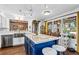 Modern kitchen with stainless steel appliances, large center island with bar seating, and backyard view at 290 Leigh Kay Dr, Lawrenceville, GA 30046