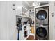 Convenient laundry room features stackable washer and dryer units with ample shelving at 290 Leigh Kay Dr, Lawrenceville, GA 30046