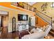 Cozy living room with hardwood floors, a fireplace and an open staircase to the upper level at 290 Leigh Kay Dr, Lawrenceville, GA 30046