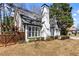 Home featuring white siding, manicured bushes and a wooden fence at 290 Leigh Kay Dr, Lawrenceville, GA 30046
