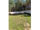Grassy backyard with white fence and trees beyond, offering privacy and outdoor space at 295 Laurelton Cir, Lawrenceville, GA 30044