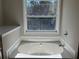 Bathroom features a soaking tub and a large window with natural light at 295 Laurelton Cir, Lawrenceville, GA 30044