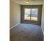 Carpeted bedroom with neutral paint and natural light at 295 Laurelton Cir, Lawrenceville, GA 30044