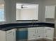 White cabinets and granite countertops with stainless steel appliances in this kitchen at 295 Laurelton Cir, Lawrenceville, GA 30044
