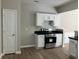 View of the kitchen with white cabinets, stainless steel appliances, and dark countertops at 295 Laurelton Cir, Lawrenceville, GA 30044