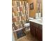 Functional bathroom with a vanity, toilet, and decorative shower curtain at 2490 Laurel Nw Cir, Atlanta, GA 30311