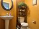 Stylish half-bathroom with a pedestal sink, toilet and decorative shelves at 2490 Laurel Nw Cir, Atlanta, GA 30311