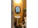 Stylish half-bathroom with a pedestal sink and decorative mirror and shelves at 2490 Laurel Nw Cir, Atlanta, GA 30311
