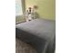 Cozy bedroom featuring a gray patterned comforter and ample natural light at 2490 Laurel Nw Cir, Atlanta, GA 30311